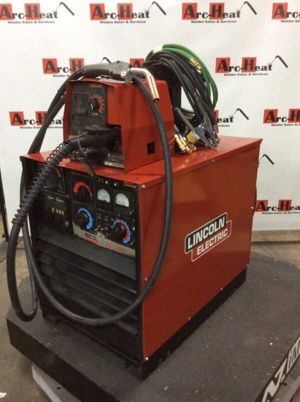 A lincoln electric wire feeder with the welding gun plugged into it.