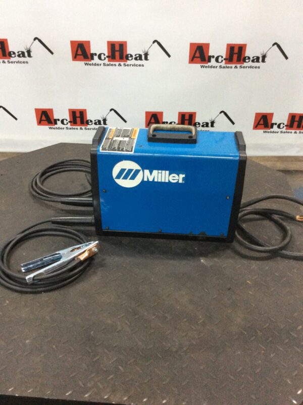 A blue miller welding machine with two wires attached to it.