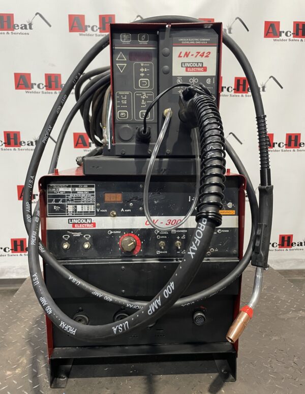 Welding machine with cables and controls.