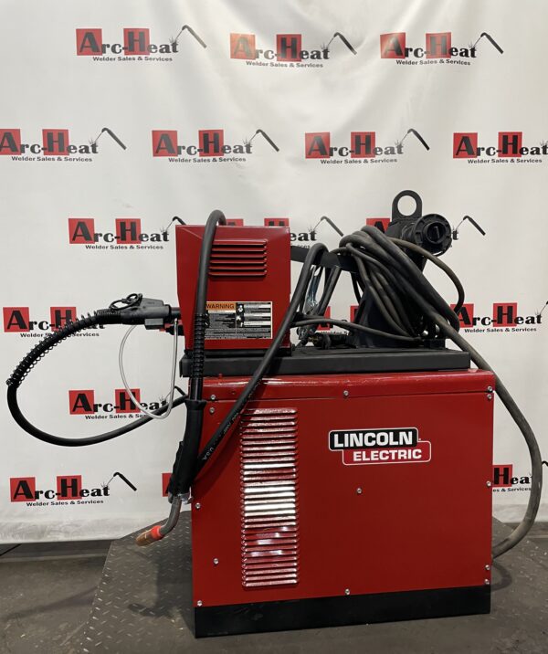Red Lincoln Electric welding machine on display.