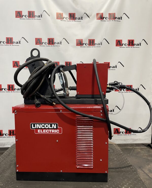 Red Lincoln Electric welding machine with cables.