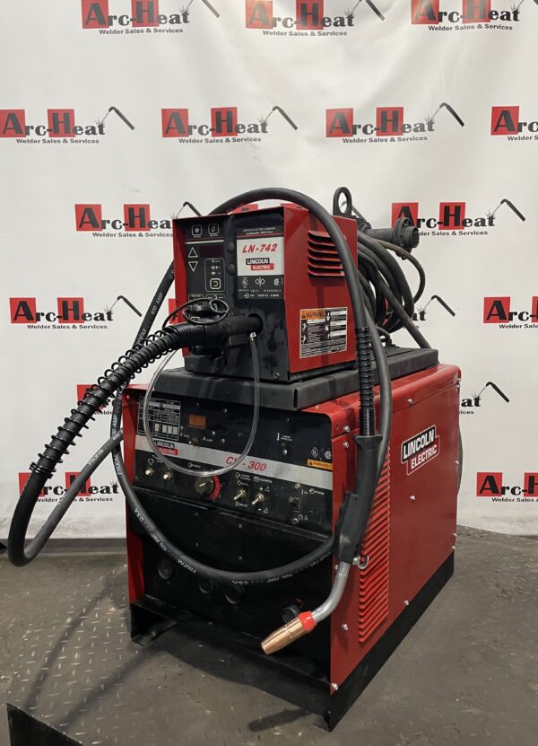 Red industrial welding machine with cables.