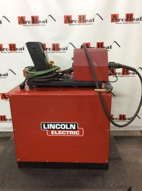 A Lincoln Idealarc CV-400 MIG Welder, also known as a Lincoln welder, with a hose attached to it.