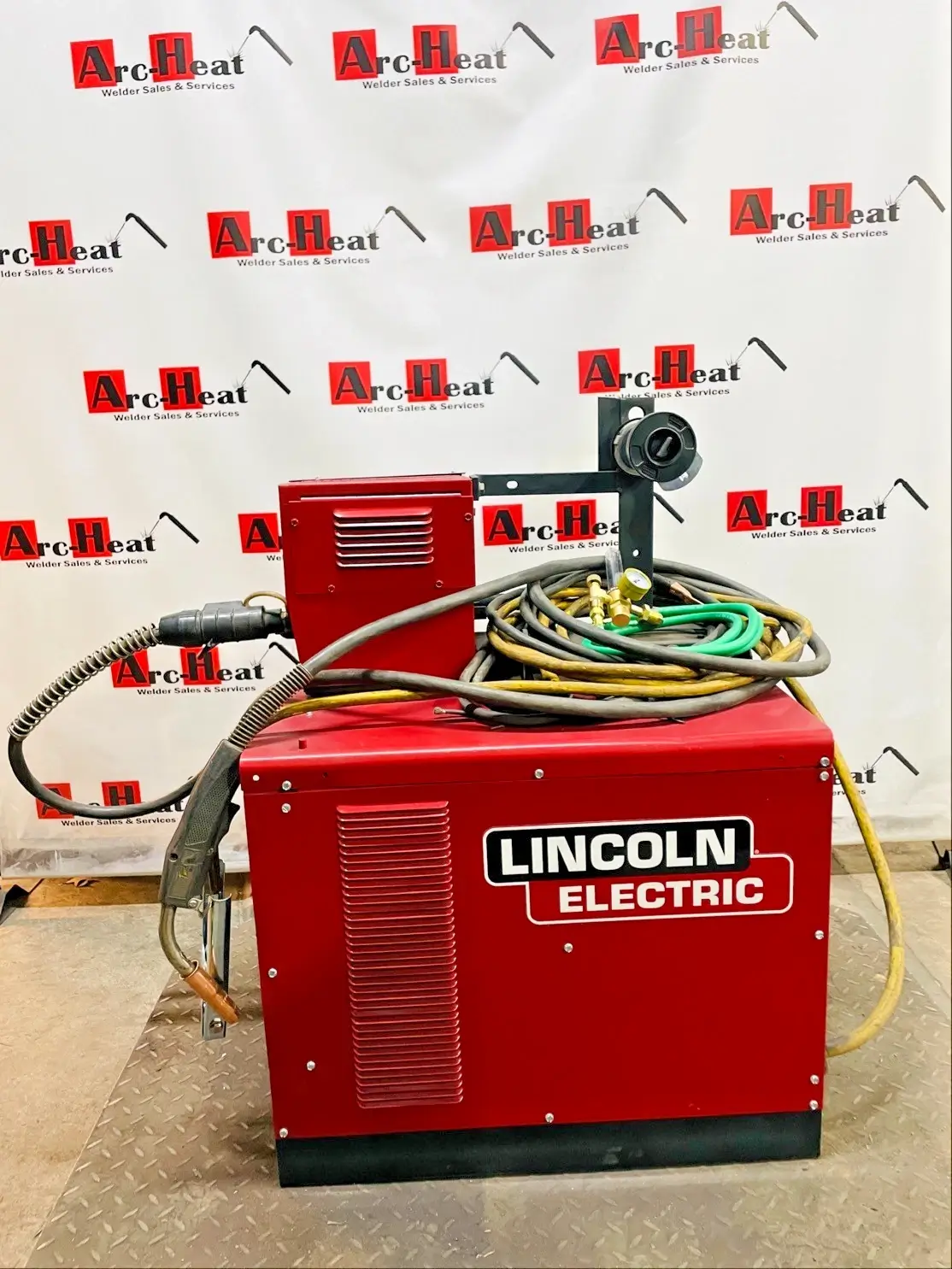 Red Lincoln Electric welding machine with hoses. Red Lincoln Electric welding machine with hoses.
