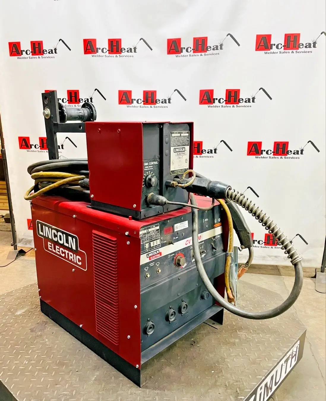 Red Lincoln Electric welding machine on stand. Red Lincoln Electric welding machine on stand.