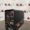 Industrial welding machine on workshop floor.