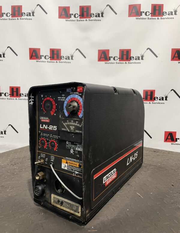Industrial welding machine on workshop floor.