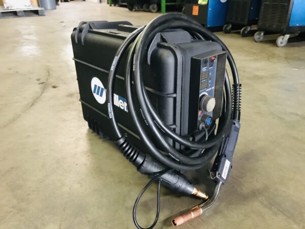 A black welding machine sitting on top of the floor.