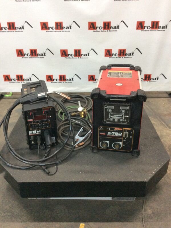 A group of three welding machines on top of a table.