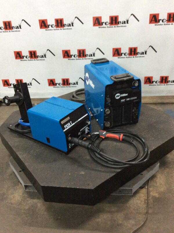 A pair of welding machines on top of a table.