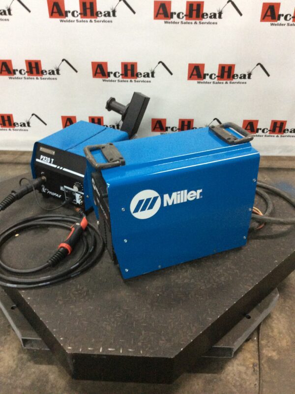 A blue miller welding machine sitting on top of a table.